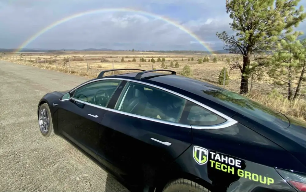 Tahoe Tech Group service vehicle under a rainbow near Reno